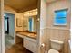 Bathroom features a classic vanity, a framed mirror and a window, offering natural light at 1921 Japonica Rd, Winter Park, FL 32792