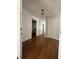 Bright foyer featuring wood floors, modern lighting, and views into the kitchen and other rooms at 1921 Japonica Rd, Winter Park, FL 32792