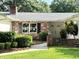 The front entrance of the home showcasing brick accents and manicured bushes at 1921 Japonica Rd, Winter Park, FL 32792
