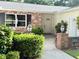 The front entrance of the home showcasing brick accents and manicured bushes at 1921 Japonica Rd, Winter Park, FL 32792