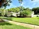 Charming one-story home featuring lush landscaping and a well-manicured lawn at 1921 Japonica Rd, Winter Park, FL 32792