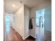 Inviting hallway with hardwood floors, multiple storage closets and a view into the kitchen at 1921 Japonica Rd, Winter Park, FL 32792