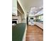 Kitchen with white cabinets, white appliances, laminate counters, wood-look floors, and an adjoining room at 1921 Japonica Rd, Winter Park, FL 32792