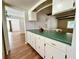 Well-lit kitchen featuring wood floors, plenty of counter space, and seamless flow to the dining area at 1921 Japonica Rd, Winter Park, FL 32792