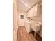 Functional laundry room with a wash sink, washer, dryer and white cabinets at 1921 Japonica Rd, Winter Park, FL 32792