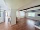 Open living room with hardwood floors and view into the kitchen and other rooms at 1921 Japonica Rd, Winter Park, FL 32792