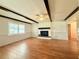 Spacious living room with hardwood floors, a brick fireplace, a ceiling fan, and natural light at 1921 Japonica Rd, Winter Park, FL 32792