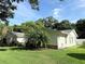 View of the house showing a well-kept lawn and a glimpse of the side entrance at 1921 Japonica Rd, Winter Park, FL 32792