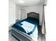 Cozy bedroom featuring a tufted headboard and updated gray floors for a stylish and comfortable retreat at 2221 Wakulla Way, Orlando, FL 32839