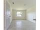 Cozy bedroom with new tile floors, white walls and trim, and a window at 2221 Wakulla Way, Orlando, FL 32839