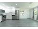 Bright, updated kitchen with stainless steel appliances, white cabinetry, and sleek gray flooring for a modern feel at 2221 Wakulla Way, Orlando, FL 32839