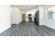 Modern kitchen with stainless steel appliances, white cabinets, and new gray flooring, ready for culinary adventures at 2221 Wakulla Way, Orlando, FL 32839