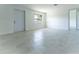 Bright living room featuring tile floors, a window, and a white front door at 2221 Wakulla Way, Orlando, FL 32839