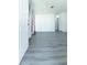 Spacious living room features new gray flooring and freshly painted white walls, offering a modern aesthetic at 2221 Wakulla Way, Orlando, FL 32839