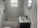Stylish bathroom features a tub with marble tile surround and a contemporary vanity at 2549 Olive Ave, Lake Wales, FL 33898