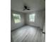 Inviting bedroom with neutral walls and gray flooring under a modern ceiling fan at 2549 Olive Ave, Lake Wales, FL 33898
