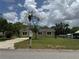Home's front exterior showing front yard, driveway, and an olive drab exterior with white framed windows at 2549 Olive Ave, Lake Wales, FL 33898