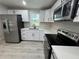 Modern kitchen featuring stainless steel appliances, sleek white cabinets, and quartz countertops at 2549 Olive Ave, Lake Wales, FL 33898