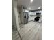 Beautiful open kitchen with stainless steel appliances, modern white cabinets, light gray flooring, and quartz countertops at 2549 Olive Ave, Lake Wales, FL 33898