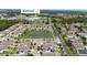 Aerial view of a residential neighborhood with lush greenery and a community pond, close to retail and amenities at 2740 Picasso Ct, Kissimmee, FL 34743