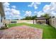 Backyard showcasing a well-manicured lawn, brick patio, and a gazebo with a dining set, creating an inviting outdoor space at 2740 Picasso Ct, Kissimmee, FL 34743