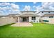 Spacious backyard with a well-maintained lawn, brick patio, privacy fence, and play equipment, creating a Gathering-friendly outdoor area at 2740 Picasso Ct, Kissimmee, FL 34743