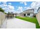 Expansive backyard featuring a gazebo with an outdoor dining set, a brick patio, lush grass, and a secure privacy fence at 2740 Picasso Ct, Kissimmee, FL 34743