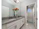 Bright bathroom featuring double sinks with granite countertops and tile flooring at 2740 Picasso Ct, Kissimmee, FL 34743