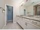 Bright bathroom featuring double sinks with granite countertops and tile flooring at 2740 Picasso Ct, Kissimmee, FL 34743