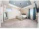 Spacious bedroom with carpet flooring, a tray ceiling and large windows with beautiful curtains at 2740 Picasso Ct, Kissimmee, FL 34743