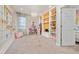 Bright bedroom featuring a creative wall display, stylish chandelier, and built-in shelving, offering a playful and organized space at 2740 Picasso Ct, Kissimmee, FL 34743