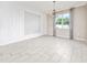 A dining room with decorative wall and lighting fixture, with light gray flooring at 2740 Picasso Ct, Kissimmee, FL 34743