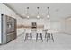 A bright kitchen with stainless steel appliances, a granite island, and pendant lighting at 2740 Picasso Ct, Kissimmee, FL 34743