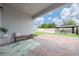 Outdoor patio features brick flooring, stylish seating, a gazebo for dining, and a well-manicured lawn for outdoor enjoyment at 2740 Picasso Ct, Kissimmee, FL 34743