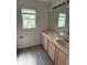 A bathroom featuring double sinks beneath a large mirror at 2833 Falling Tree Cir, Orlando, FL 32837