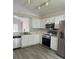 Well-lit kitchen with stainless steel appliances, including a range and microwave at 2833 Falling Tree Cir, Orlando, FL 32837