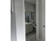 A small bathroom with gray walls, a vanity with a white countertop, and a toilet at 2853 Willowseed Ln, St Cloud, FL 34772
