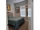 Simple bedroom with neutral tones, a comfortable bed, and window with bright, natural light at 2853 Willowseed Ln, St Cloud, FL 34772
