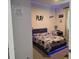 Vibrant, stylish bedroom with a gaming theme, featuring playful decor and LED lighting accents at 2853 Willowseed Ln, St Cloud, FL 34772
