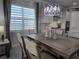 Dining area with a chandelier and decorative centerpieces and access to kitchen at 2853 Willowseed Ln, St Cloud, FL 34772