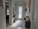 Bright foyer with decorative console table, neutral decor, and stylish tiled flooring at 2853 Willowseed Ln, St Cloud, FL 34772