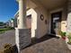 Inviting front porch with stone pillars and a 'Welcome' sign, leading to a warm and inviting home at 2853 Willowseed Ln, St Cloud, FL 34772