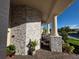 Stone-accented porch with columns and views of exterior landscaping at 2853 Willowseed Ln, St Cloud, FL 34772