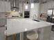 Bright kitchen featuring a large island, stainless steel appliances, and modern pendant lighting at 2853 Willowseed Ln, St Cloud, FL 34772