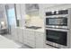 Modern kitchen includes stainless appliances, shaker cabinets, a gas cooktop, and a double oven at 2853 Willowseed Ln, St Cloud, FL 34772