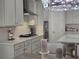 A modern kitchen includes stainless appliances, shaker cabinets, a gas cooktop, and a large island at 2853 Willowseed Ln, St Cloud, FL 34772