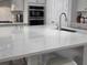 Kitchen island featuring a quartz countertop, stainless steel sink, and chrome faucet at 2853 Willowseed Ln, St Cloud, FL 34772