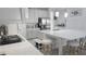 Bright kitchen with a large island with seating, stainless steel appliances, and pendant lighting for a modern feel at 2853 Willowseed Ln, St Cloud, FL 34772