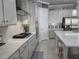 Well-lit kitchen featuring stainless steel appliances, quartz countertops and decorative backsplash at 2853 Willowseed Ln, St Cloud, FL 34772