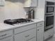 Modern kitchen featuring stainless appliances, shaker cabinets, a gas cooktop, and a spice rack at 2853 Willowseed Ln, St Cloud, FL 34772